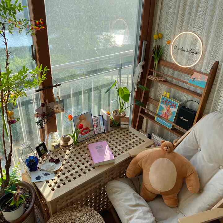 Natural color tone veranda space featuring wooden furniture and plants creating a cozy home cafe interior