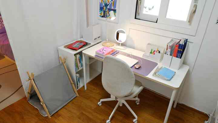 A small white and wood-toned home office space featuring a desk and office chair, showcasing a neat and functional work environment