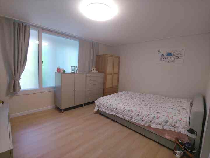 Natural beige-toned 6-mat bedroom featuring a bed, dresser, and curtains, creating a cozy and clean atmosphere