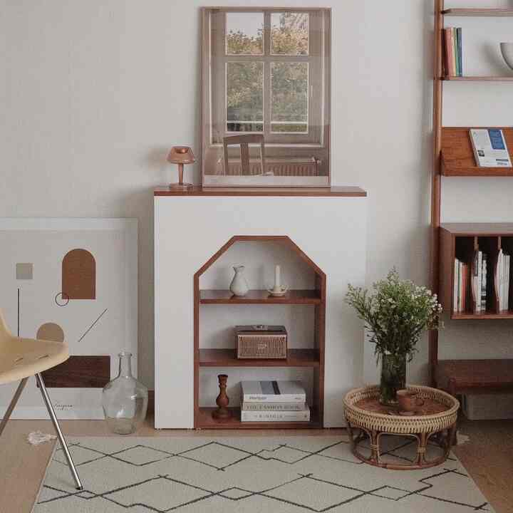 Natural wood tone living room featuring simple modern furniture and plants with a cozy atmosphere