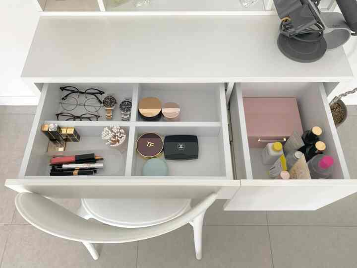 Minimal storage solution space with white vanity and chair in a clean, white-toned interior