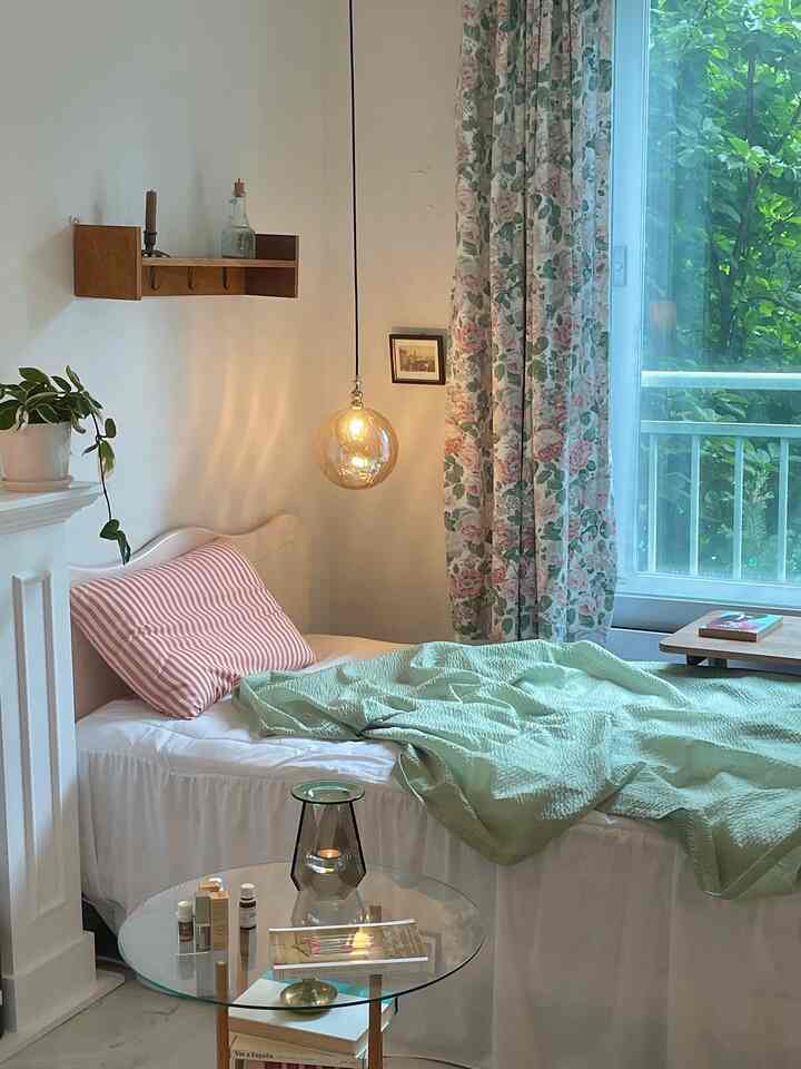 White and natural wood tone bedroom featuring aroma lamp and summer quilt, creating a cozy atmosphere