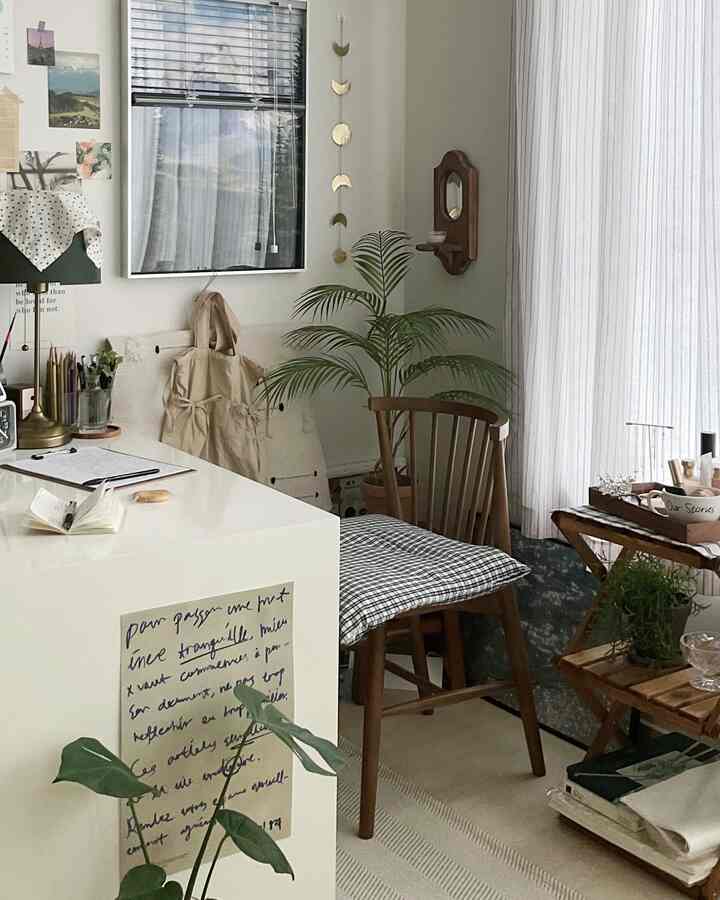Natural tone and wood tone dining room featuring a simple dining chair and white table in a tidy setting
