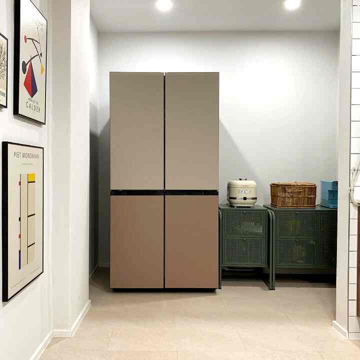 Beige and green toned kitchen featuring a central Bespoke refrigerator and drawer units with a rice cooker on the right, creating a neat space