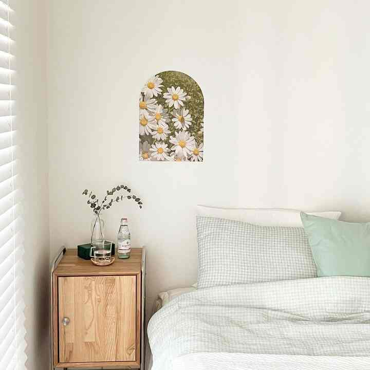 Bright mint bedding and wood-toned nightstand in a simple, natural bedroom space