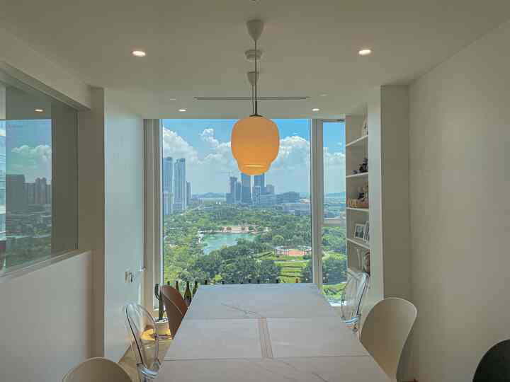 Modern dining room with white and transparent elements, featuring a large window and a marble dining table with natural wood flooring