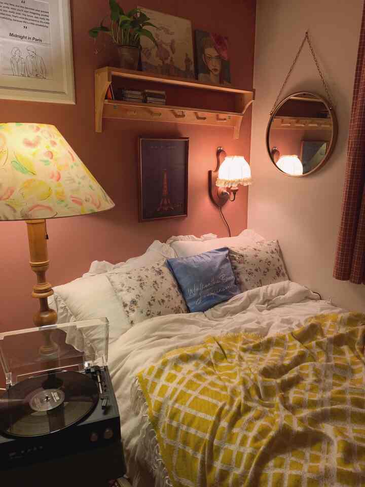Warm brown-toned bedroom featuring vintage decor, white bedding, and a cozy yellow checkered throw blanket