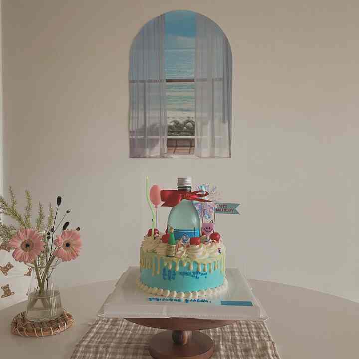 Beige-toned round dining space featuring an arched wall art and natural wood cake stand