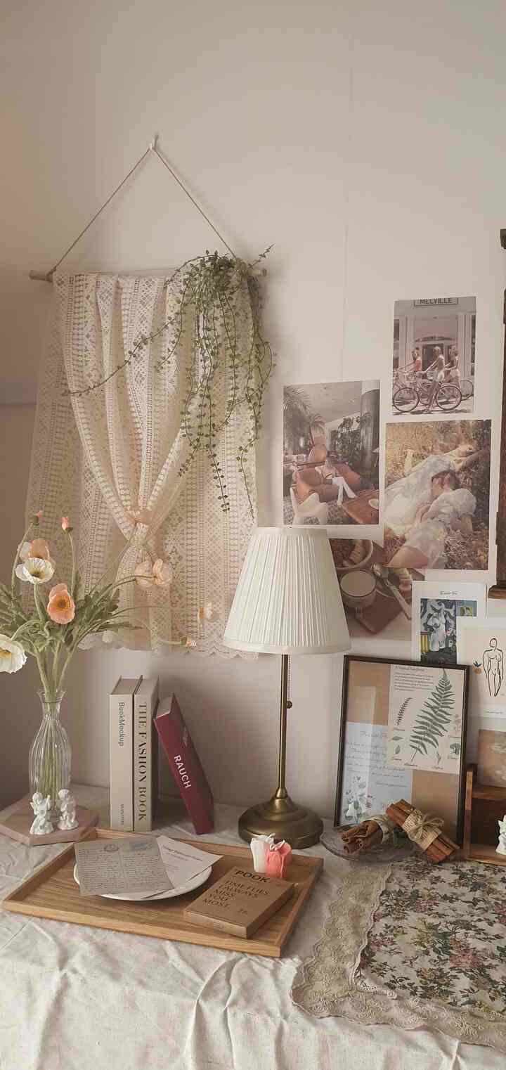 Natural tone wall area featuring vase, placemat, candles and cozy decorative objects