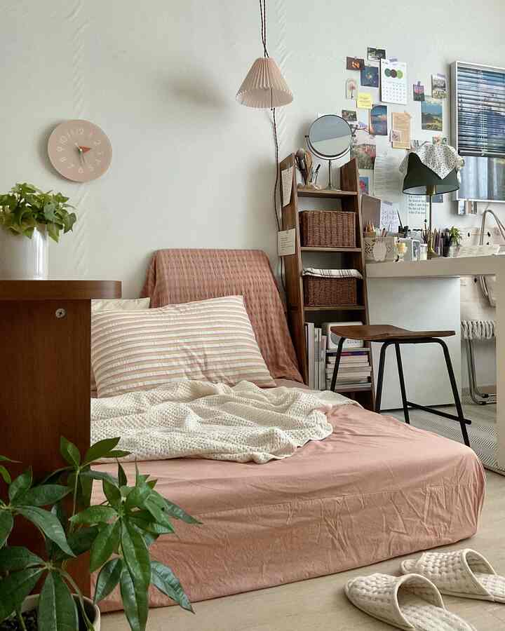 Soft white and brown toned single bedroom featuring wooden furniture and cozy bedding with a natural atmosphere