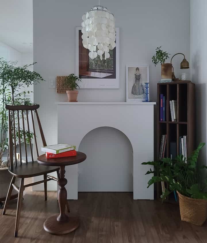 Natural wood furniture and framed art with plants arranged in a calm, simple Nordic style living room
