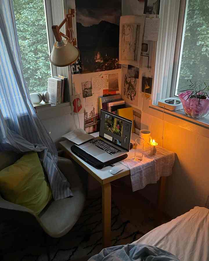 Cozy natural-toned home office and study for single household, featuring candlelight and plants creating a calm atmosphere