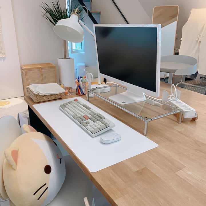Minimal natural home office with white and wood tones, featuring a neat desk and office chair