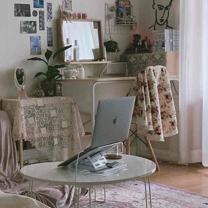 White and beige toned living room featuring vintage rug and vanity with cozy atmosphere