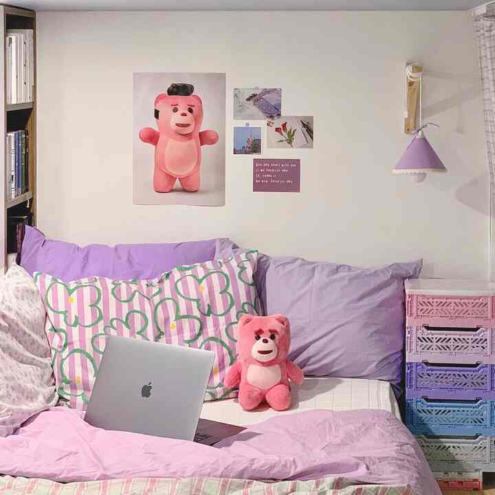 Pastel purple and pink toned single bedroom featuring cute bear plush and poster with cozy atmosphere