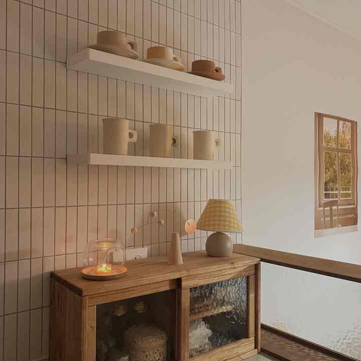 Warm and cozy space featuring soft wood tones, natural colors, wall shelves, and a wooden storage cabinet