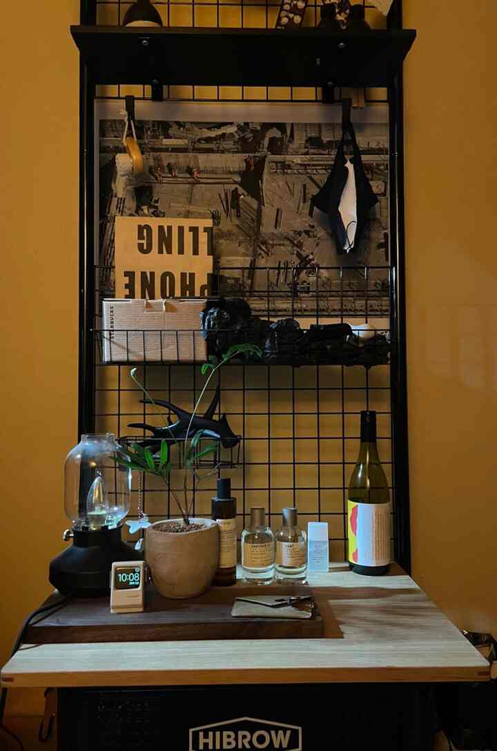 Warm beige and black toned home office featuring wood table and metal wall decor, creating cozy atmosphere