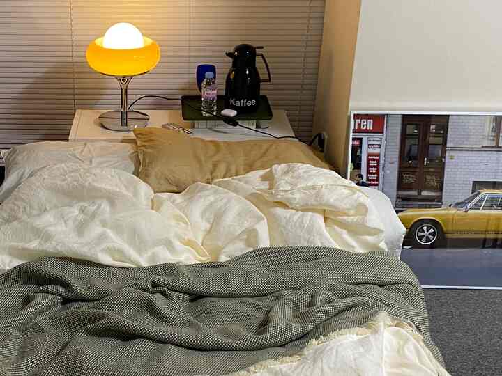 White and yellow toned bedroom featuring duvet cover and blanket creating a cozy atmosphere