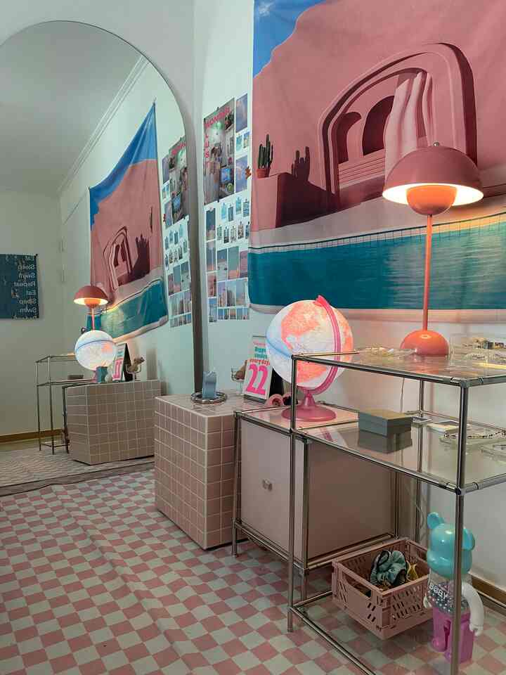 Bedroom with pink and blue tones featuring tiled furniture and table lamps in a cute interior setting
