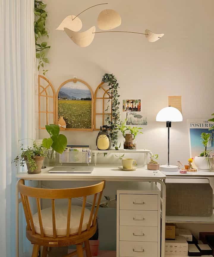 White and wood tone home office featuring a desk, dining chair, and table lamp with a simple, natural atmosphere