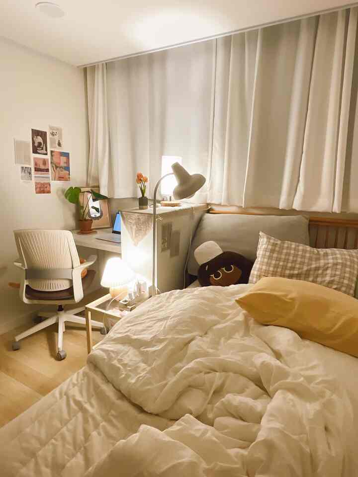 Warm beige and white toned single bedroom featuring a separated workspace and a cozy bed creating a comfortable atmosphere