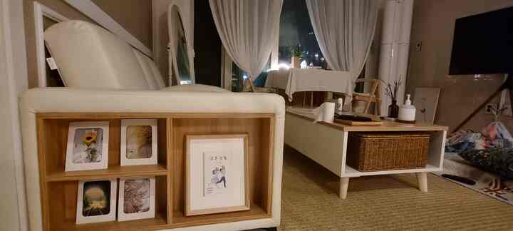 Natural tone living room featuring a white sofa, wooden coffee table, and a rattan storage basket creating a cozy atmosphere