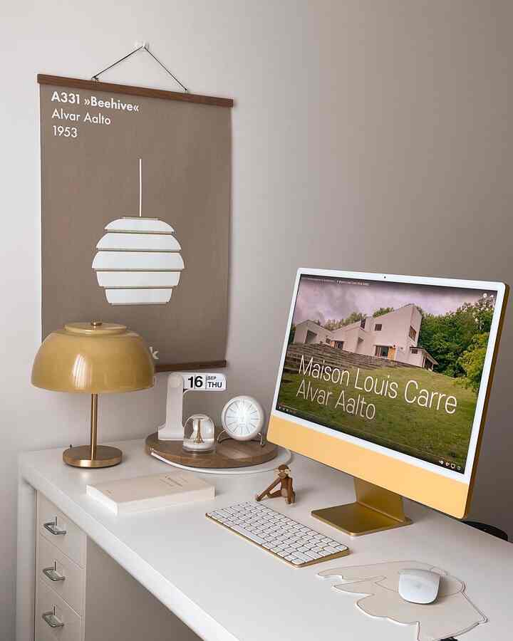 Yellow and white toned study featuring an iMac and table lamp in a clean and minimal digital workspace