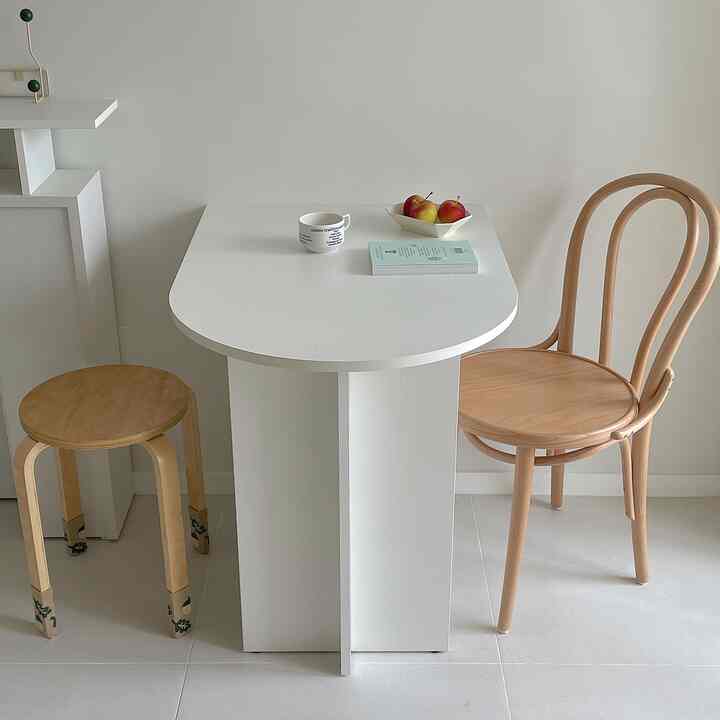 White and wood tone two-person home cafe dining space with simple and clean atmosphere