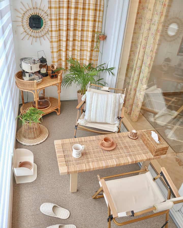 Natural warm-toned veranda home cafe featuring rattan furniture and plants arranged for a cozy atmosphere