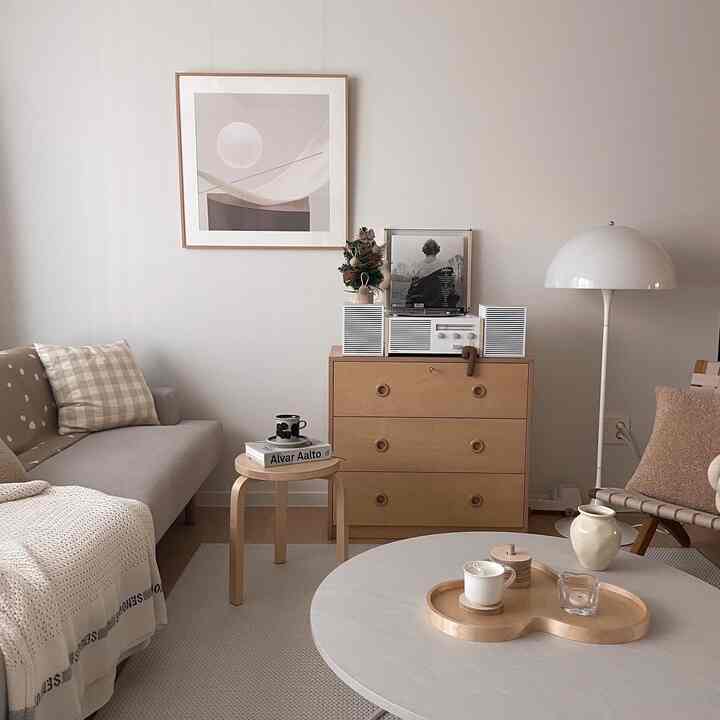 Natural modern living room featuring beige sofa and wood tone furniture with a warm and cozy atmosphere