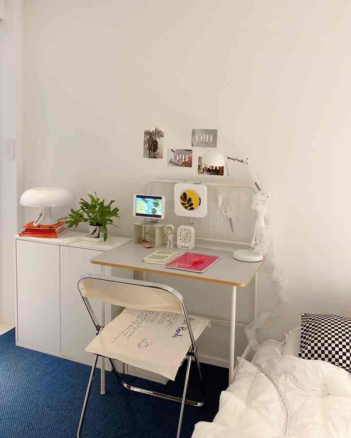 White and blue toned studio bedroom featuring a desk and white furniture with a modern study atmosphere