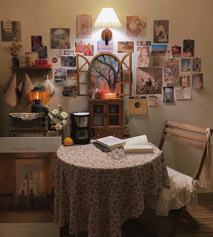 Warm wood tones vintage home cafe featuring floral tablecloth, wooden furniture, and artistic wall decor for cozy ambiance