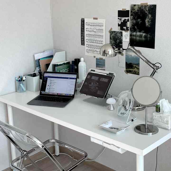 Minimal white and transparent materials blend in a single household home office desk space