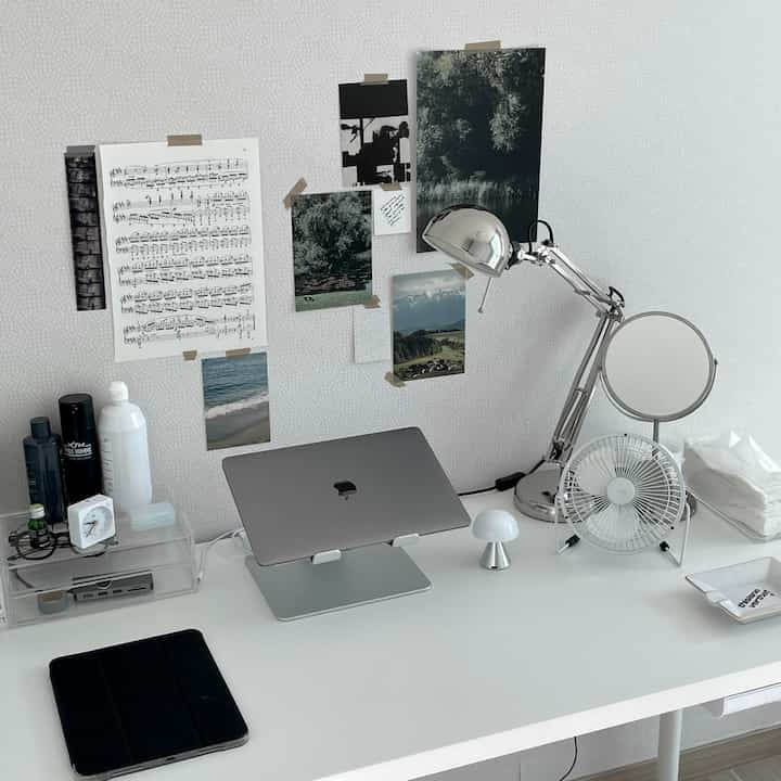 White and silver-toned home office featuring a clean desk and lamp with a modern atmosphere