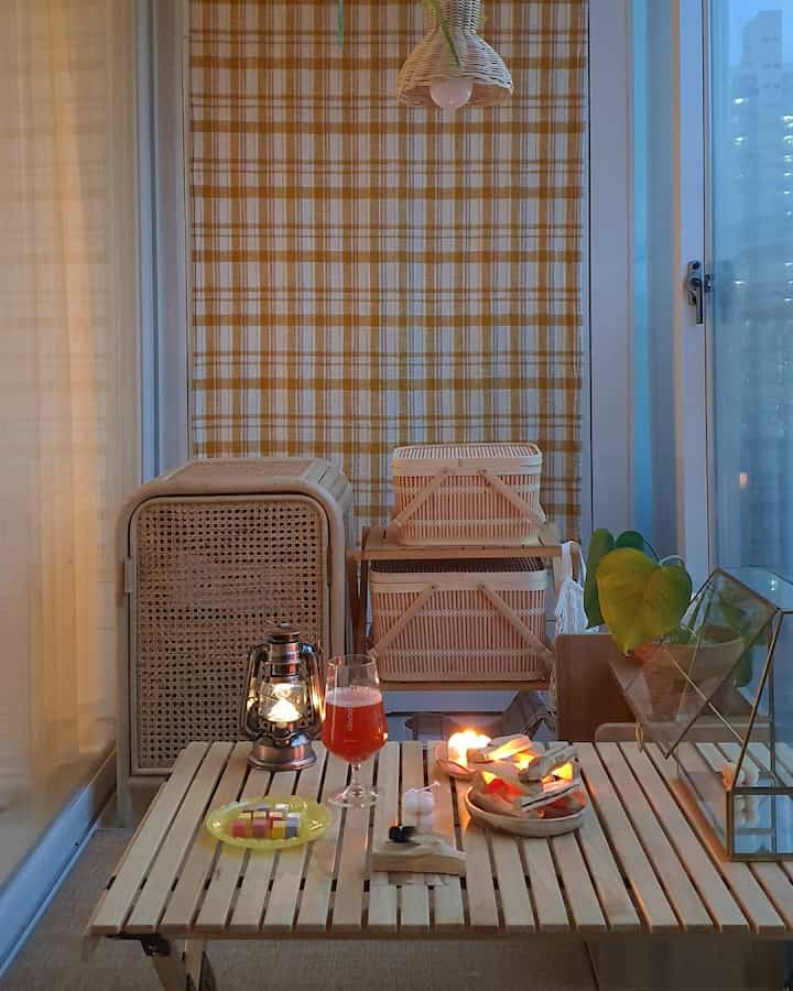 Beige-toned veranda space featuring rattan storage cabinets and camping accessories with a natural home camping ambiance