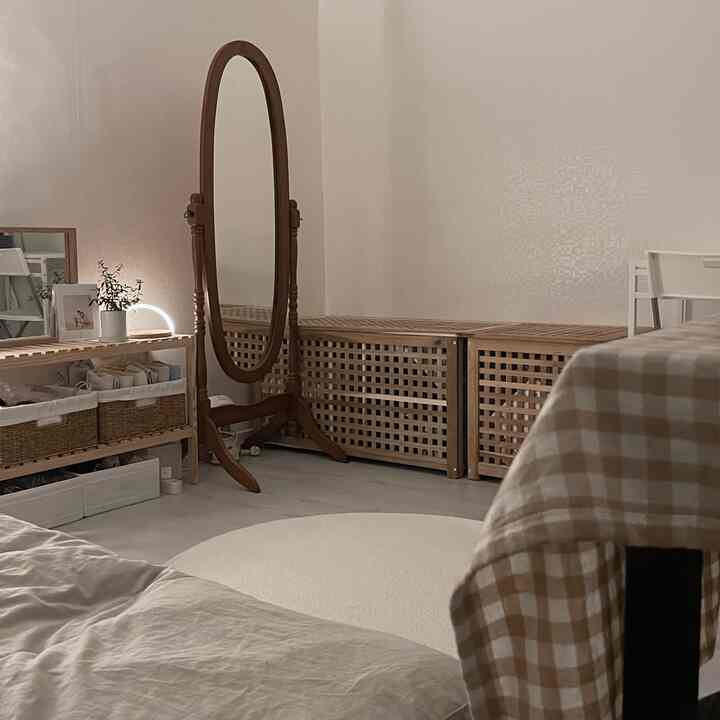 Natural-toned bedroom featuring wooden furniture and storage benches neatly arranged for a cozy atmosphere