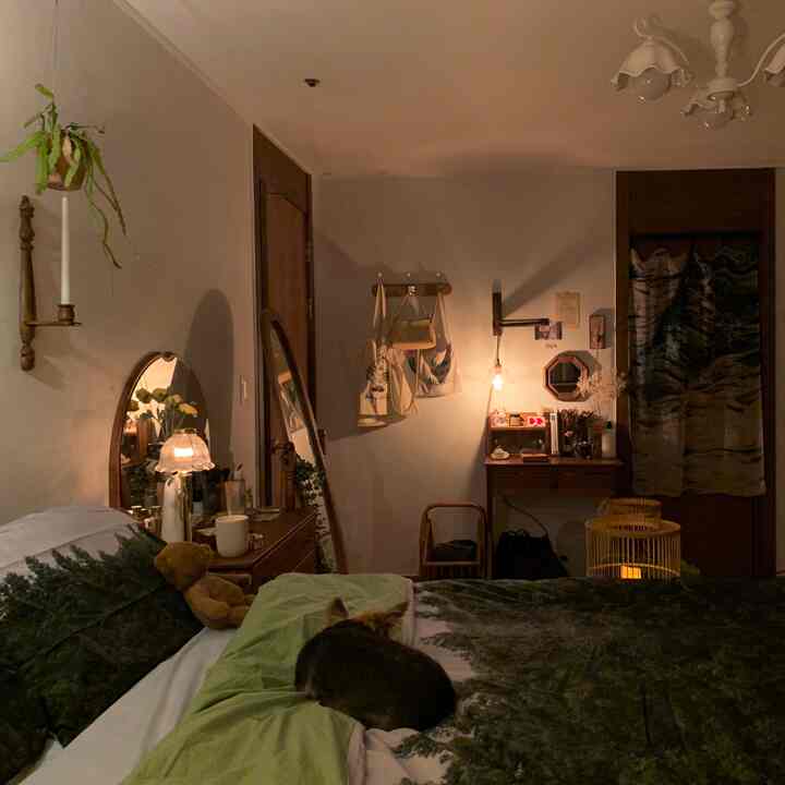 Natural color tone bedroom featuring bed and vintage wooden furniture arranged in a cozy warm atmosphere