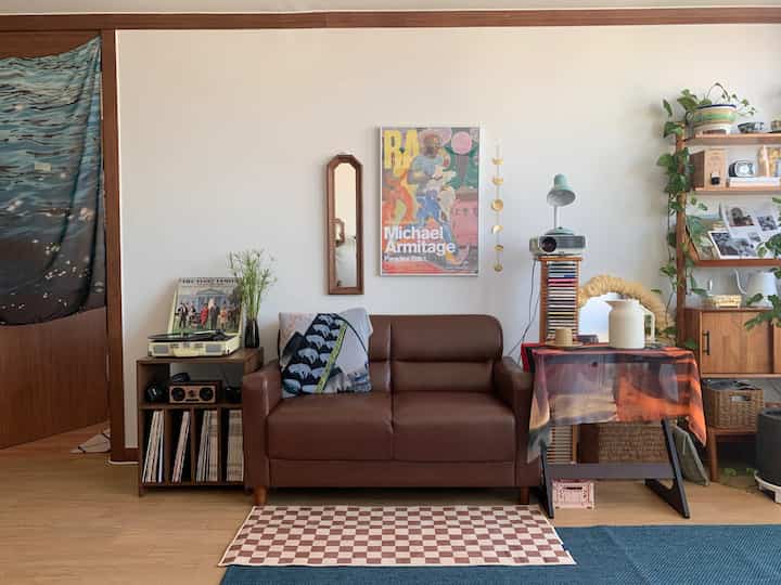 Brown and wood-toned mid-century modern living room featuring leather sofa and vintage decor creating a cozy atmosphere
