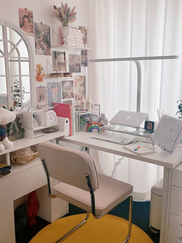 White-toned compact study space featuring a desk, modern chair, and a wide desk lamp with cozy work atmosphere
