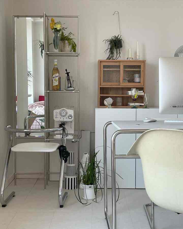 A white and natural toned home office featuring a coffee machine and storage cabinet in a clean interior