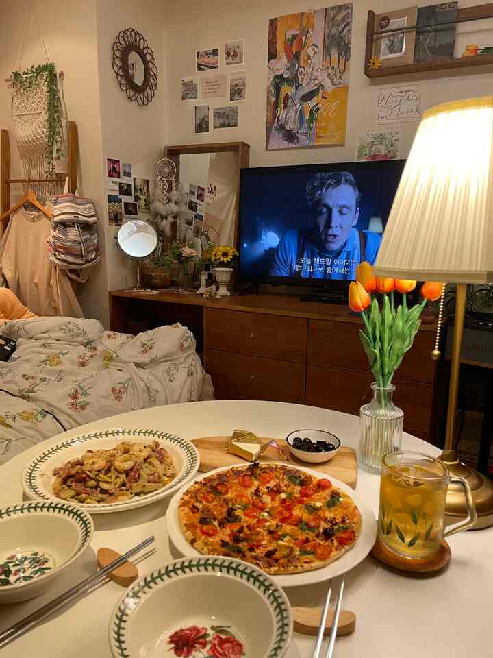 Beige and brown toned living room featuring wooden vanity and dresser, lamp, and posters creating a cozy interior
