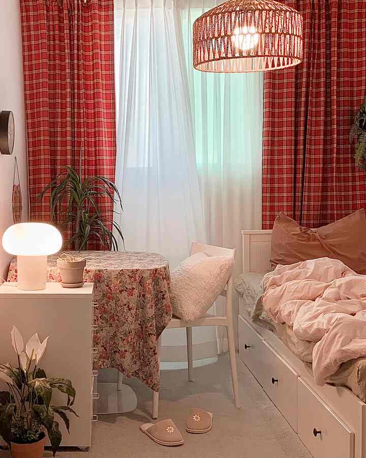 Cozy kids' room with red check curtains, white furniture, a neat bed, and a floral tablecloth creating a warm atmosphere
