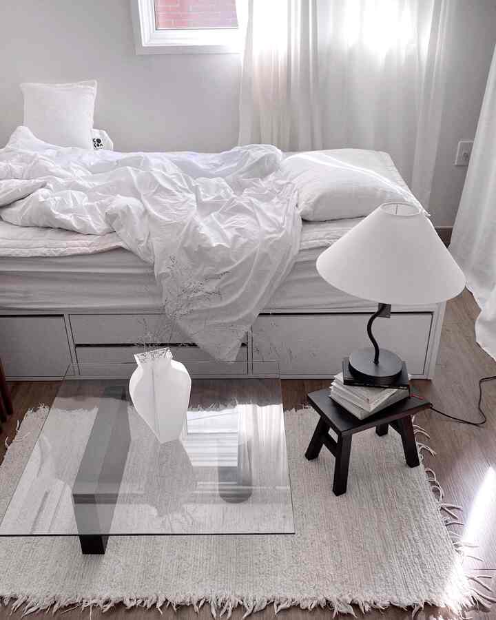 Minimal bedroom with white and wood tones, featuring a clean and simple atmosphere