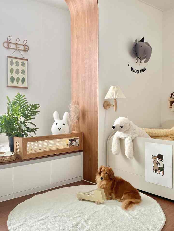 Natural wood tone and beige bedroom featuring cozy toys and a dog creating a warm atmosphere