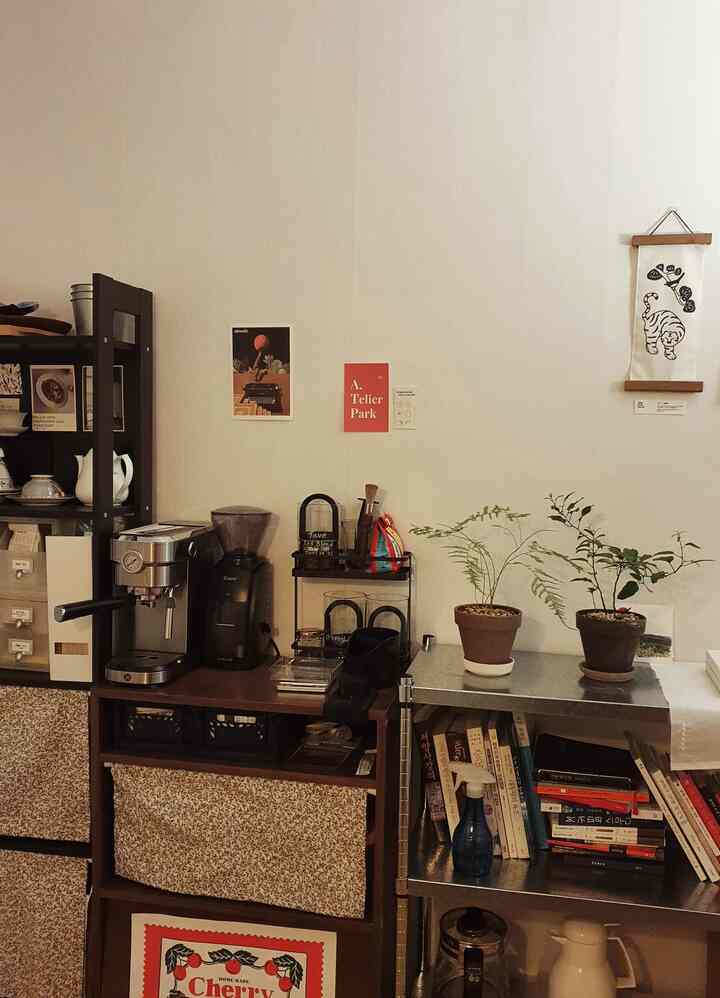 Dining room wall with brown wood tones and white background, featuring coffee machine and grinder in a home cafe setup