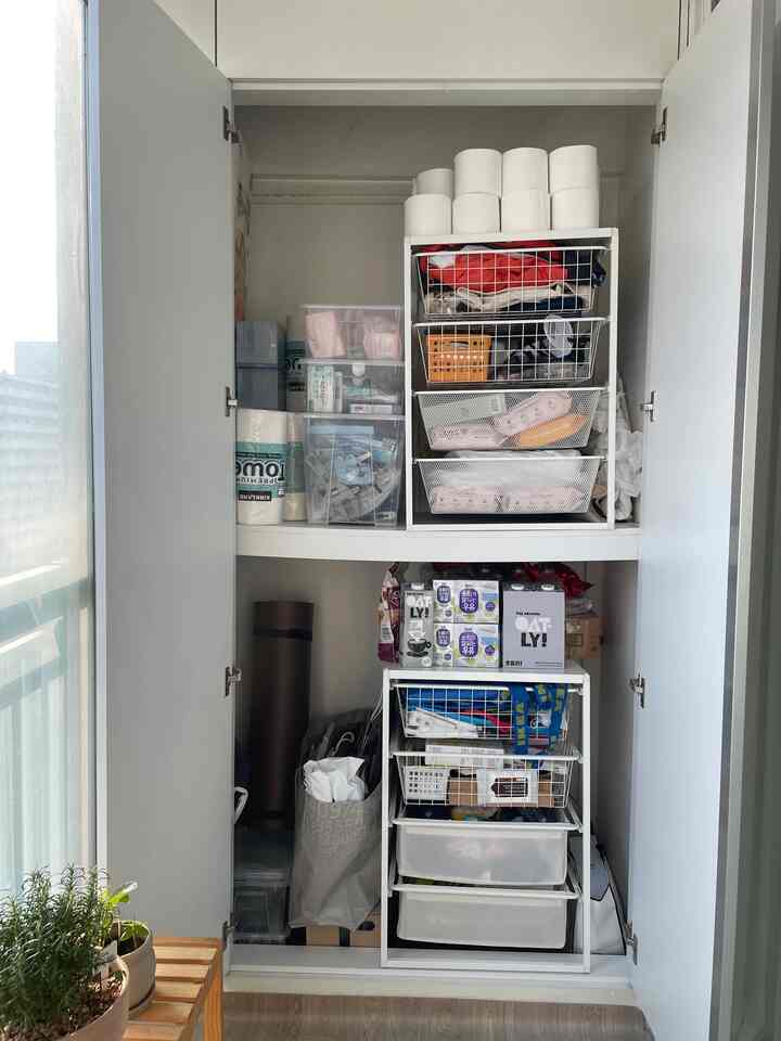 White storage cabinet with IKEA JONAXEL drawers in a veranda storage space, neat and practical organization