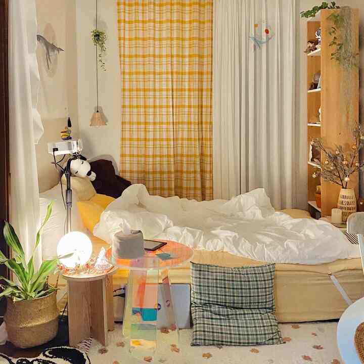 Natural-style bedroom with yellow check curtains and white bedding creating a cozy atmosphere