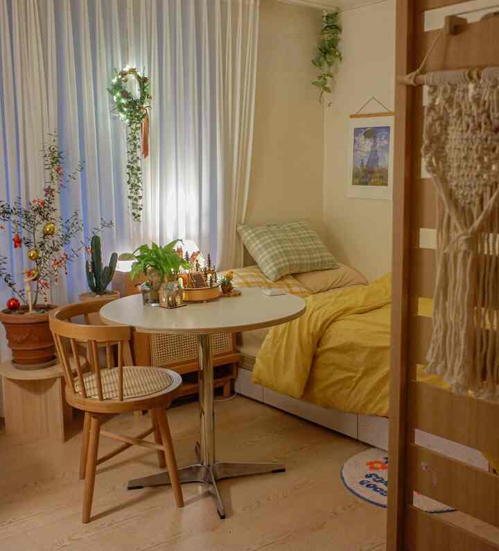 Natural-toned small bedroom featuring wood furniture and yellow bedding in a cozy interior