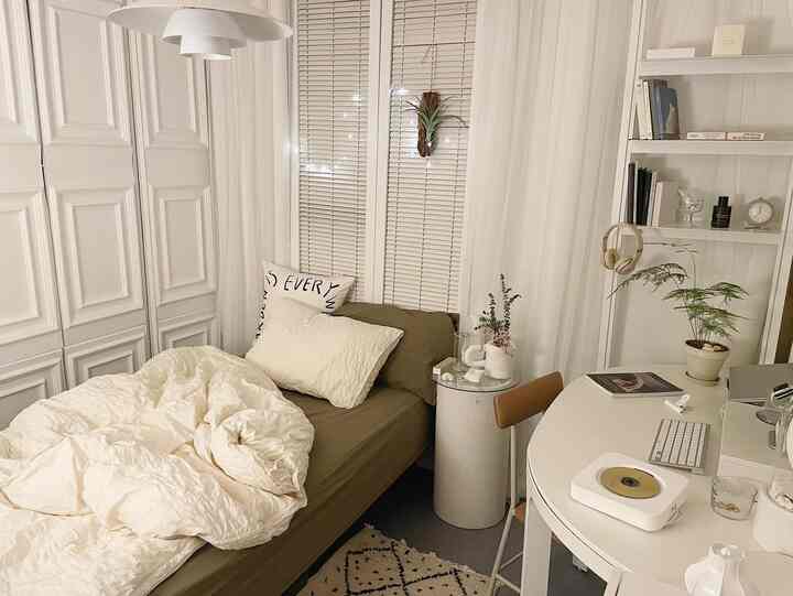 A cozy small 3-pyeong bedroom in white and beige tones featuring a single bed, desk, and shelves with a simple and warm atmosphere