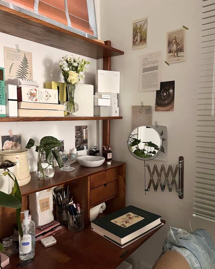 Natural tone small space featuring a wooden desk with shelves and a vanity mirror creating a cozy and comfortable interior